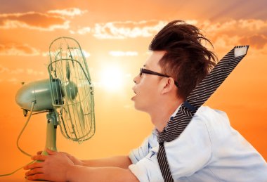 Картина, постер, плакат, фотообои "the heat wave is coming, business man holding a electric fan
", артикул 48649139