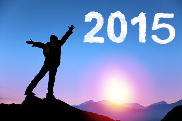 happy new year 2015.young man standing on the top of mountain