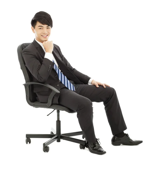 Confident Young business man sitting in a chair — Stock Photo, Image