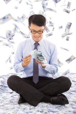 business man counting money with money rain background clipart