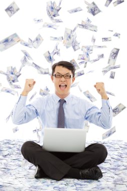 Business man make a victory gesture with money rain clipart