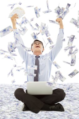 Business man winning a lottery with money rain background clipart