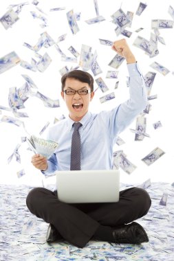 Business man holding money and make a win pose clipart