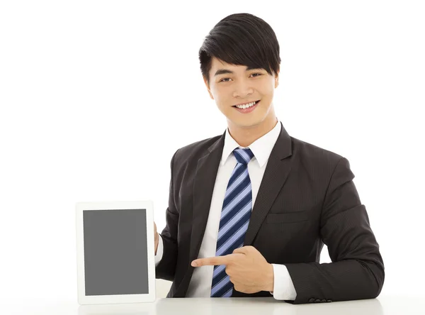 Sonriente joven hombre de negocios mostrar una tableta — Foto de Stock