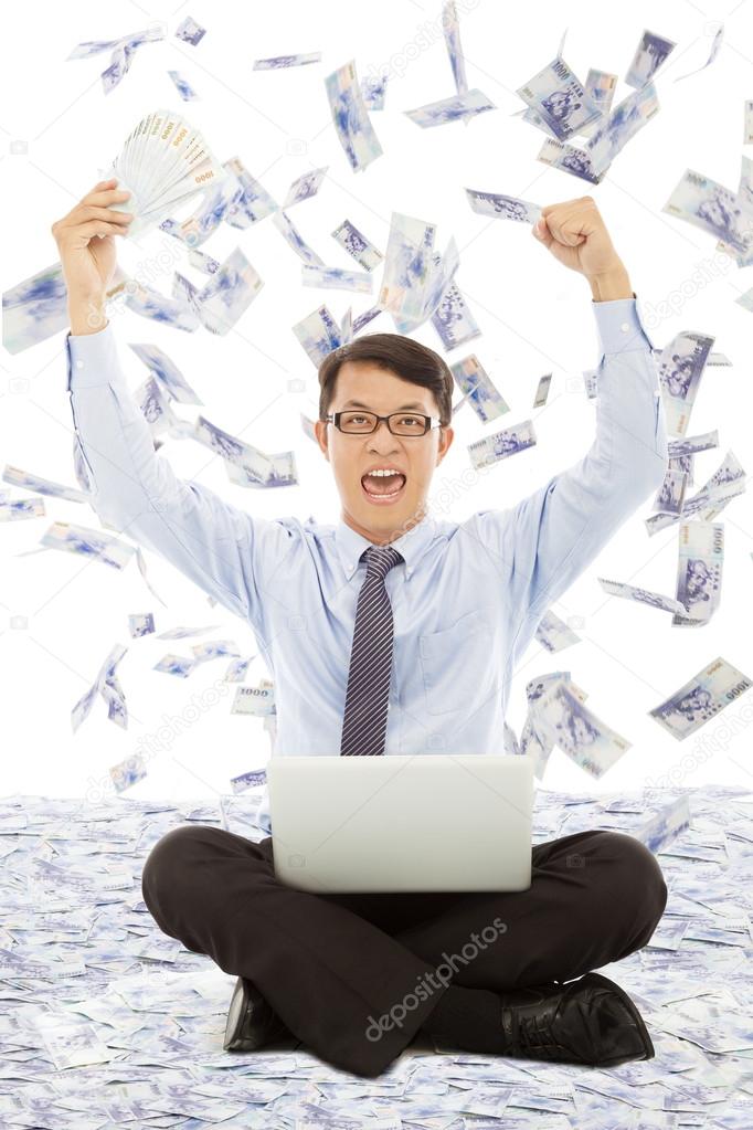 Business man holding money  and raising hands