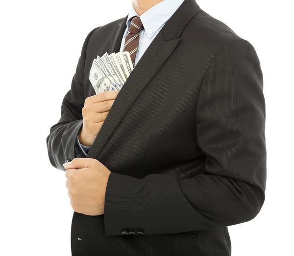 Affärsman att lägga pengar i fickan med vit bakgrund — Stockfoto