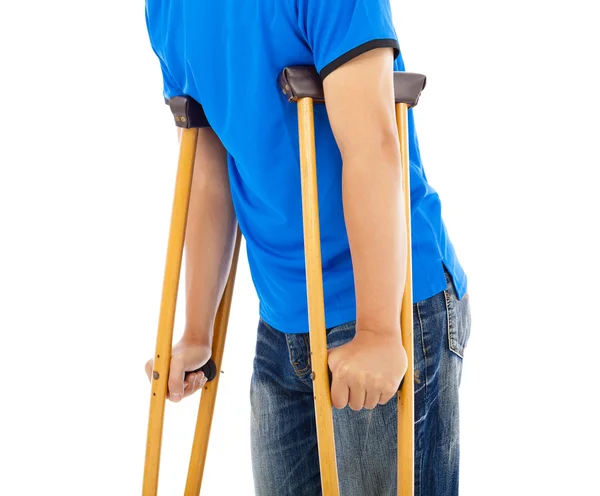Close up of young man on crutches. white background — Stock Photo, Image