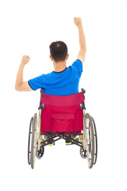 handicapped man sitting on a wheelchair and fist pose clipart