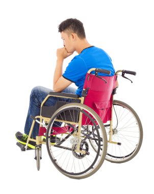 handicapped man sitting on a wheelchair and thinking clipart