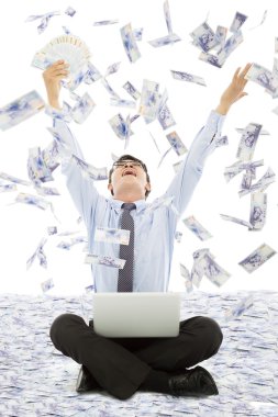 Business man winning a lottery with money rain background clipart