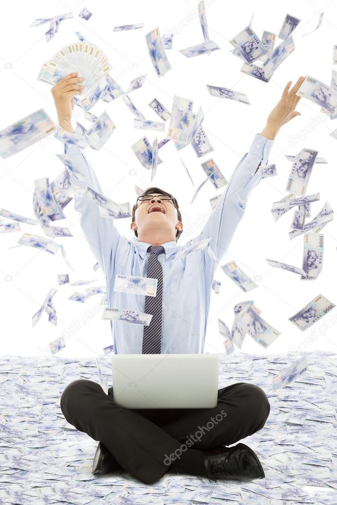 Business man winning a lottery with money rain background