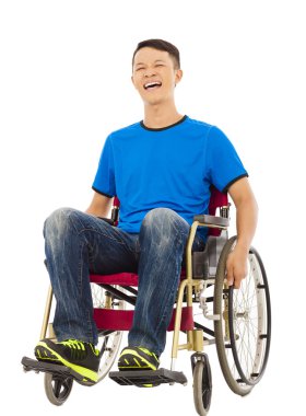 hopeful young man sitting on a wheelchair in studio clipart