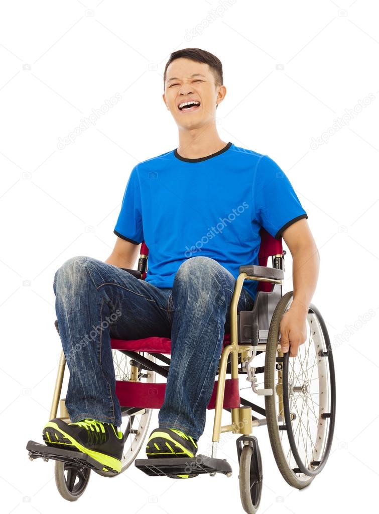 hopeful young man sitting on a wheelchair in studio