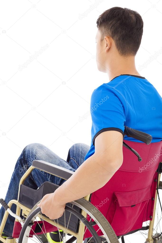 handicapped man sitting on a wheelchair and thinking