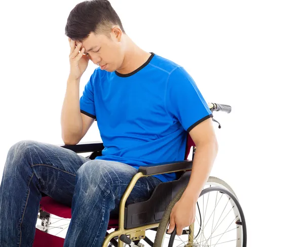 Upset handicapped man sitting on a wheelchair — Stock Photo, Image