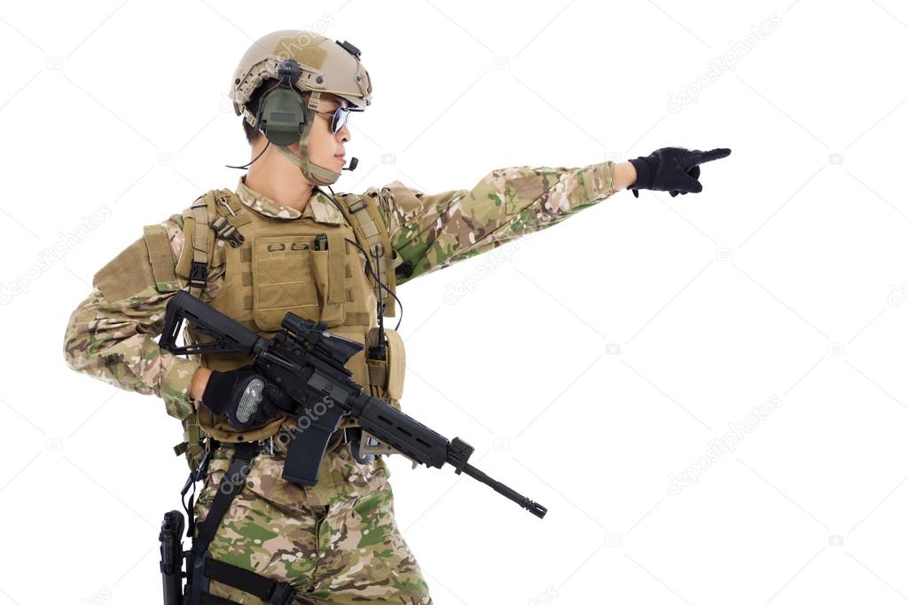 Soldier holding rifle or sniper and directing