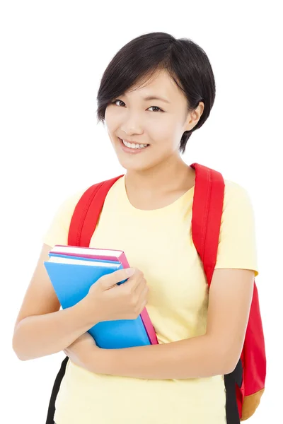 Lächelnde Studentin steht vor weißem Hintergrund — Stockfoto