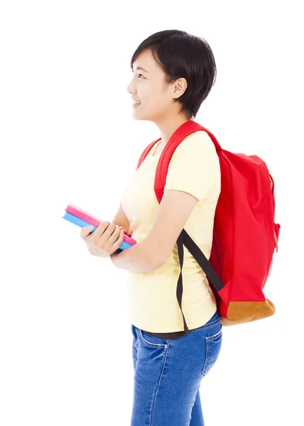 Joven estudiante chica de pie y sosteniendo libro — Foto de Stock