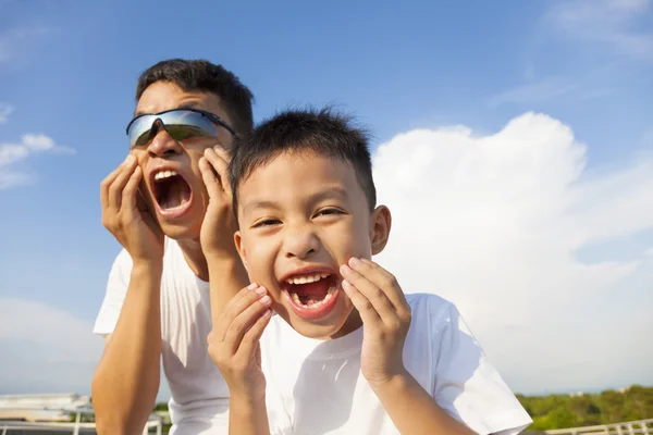 Father and son making a grimace together in the park — Stock Photo, Image