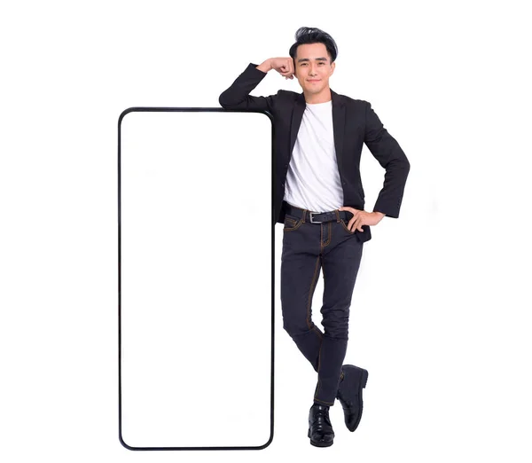 Happy Young Man Standing Leaning Big Smartphone Blank White Screen — Stockfoto
