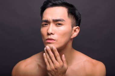 Tıraşlı, pürüzsüz, yumuşak tenli, kendinden emin, yakışıklı bir erkeğin dokunuşuna yaklaş. 