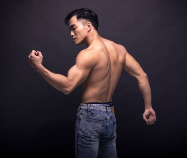 Rear view of  muscular asian young man