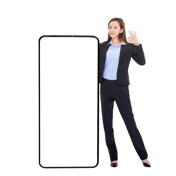 Business Woman Leaning Huge Cellphone Blank White Screen Showing Gesture — стоковое фото