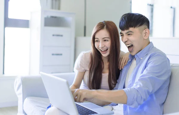 Excited Young Happy Couple Resting Sofa Living Room Searching Internet — Foto Stock