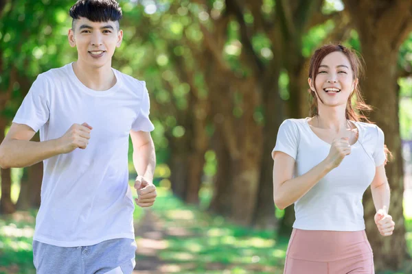 Young Couple Jogging Together Park Sunny Day — ストック写真