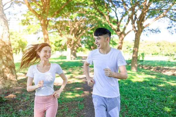Happy Young Couple Jogging Park Sunny Day — стоковое фото