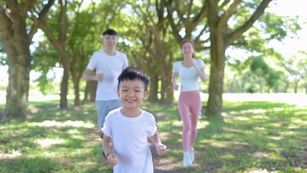 Happy Boy Jogging Parents City Park — Video Stock