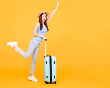 Happy young woman with  luggage isolated on yellow background ,summer,travel concept.