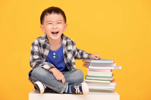 Happy Kid Sitting Books Isolated Yellow Background — Photo