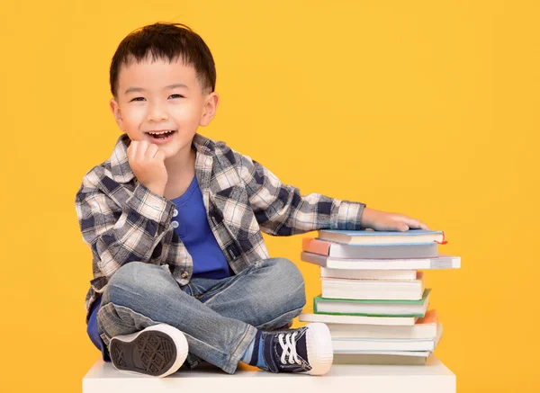 Happy Little Boy Sitting Books Isolated Yellow Background — Foto Stock