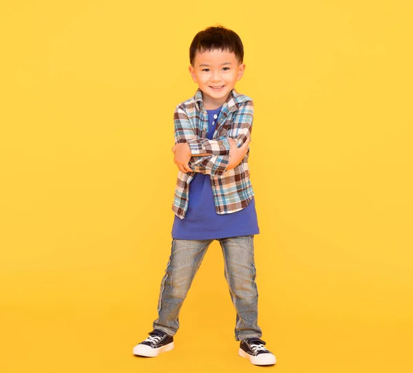 Happy Asian Kid Standing Yellow Background — Zdjęcie stockowe