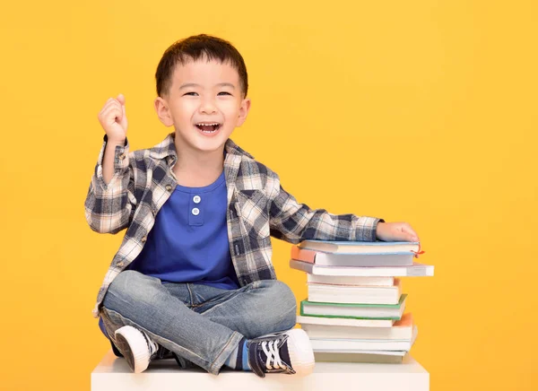 Happy School Boy Sitting Books Isolated Yellow Background — Fotografia de Stock