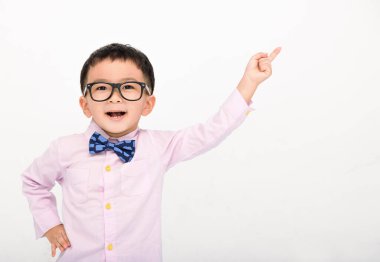 Happy Boy in a suit  and pointing to copy space