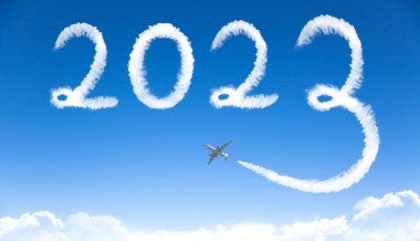Mutlu yıllar 2023 konsepti. Bulutlar gökyüzünde uçakla çiziyor