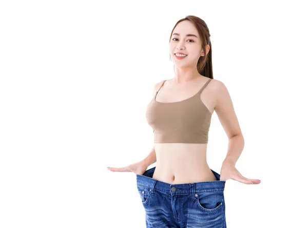 Happy Thin Girl Mostrar Perda Peso Jeans Grandes Velhos — Fotografia de Stock