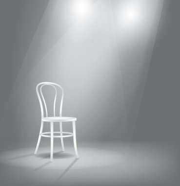 Stage with white chair in spotlights