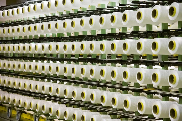 许多有白线的筒子被用来生产织物 — 图库照片