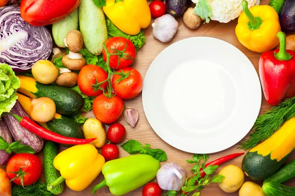 Legumes orgânicos frescos em torno da placa branca — Fotografia de Stock