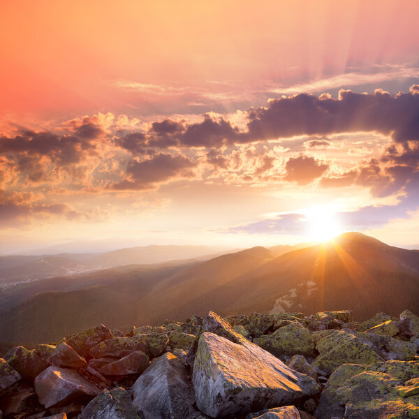 Sunset in the mountains landscape. Dramatic sky,  colorful stone