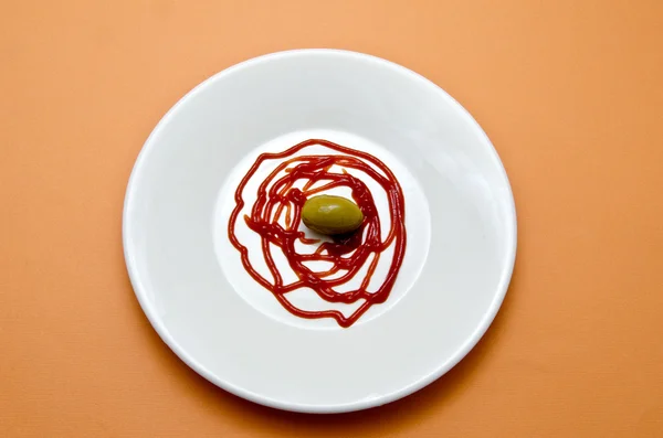 Olive with ketchup — Stock Photo, Image