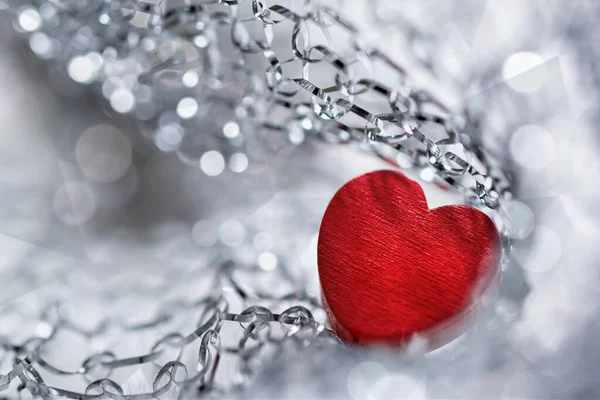 Red heart in silver chains. Photo — Stock Photo, Image