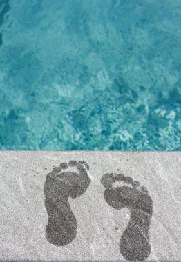 Two wet foot steps by swimming pool clipart