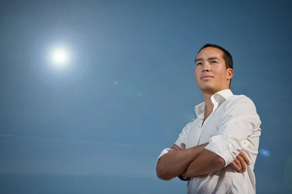 Asian man standing with arms folded — Stock Photo, Image