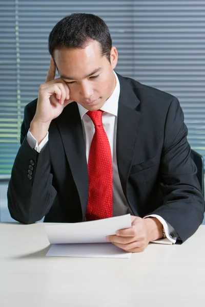 Smart eurasian business man browsing documents — Stock Photo, Image