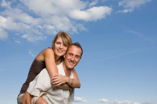 Young lovers piggy back Stock Photo