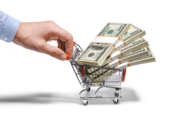 Businessman's hand & steel grocery cart full of money stacks - isolated on white background